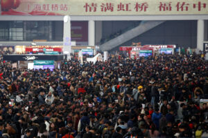 Passengers wait to board trains in Shanghai